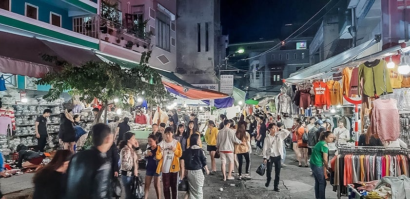 Local night market and street activity near Hanvico Building in central Da Nang